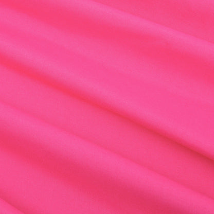 Experience the luxurious feel of our Microfiber Sheet Set With Extra Pillowcases, featuring bright pink fabric adorned with soft folds running diagonally across the surface—creating gentle shadows and a smooth texture reminiscent of luxury bedding.