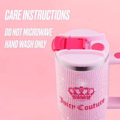A pink Diamond Bling Stainless Steel Tumbler with Handle and Straw, 30 oz by Juicy Couture is shown, featuring rhinestones and a crown logo. Text reads: “Care instructions. Do not microwave. Hand wash only.” Both the background and lid are pink.