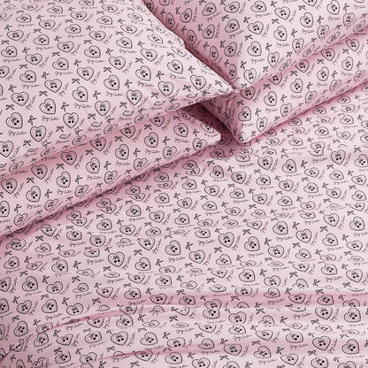 The Microfiber Sheet Set With Extra Pillowcases features a pink design with black outlined cartoon animal faces, bows, and decorative circles. This luxury bedding set looks soft, neatly arranged, and includes additional pillowcases.