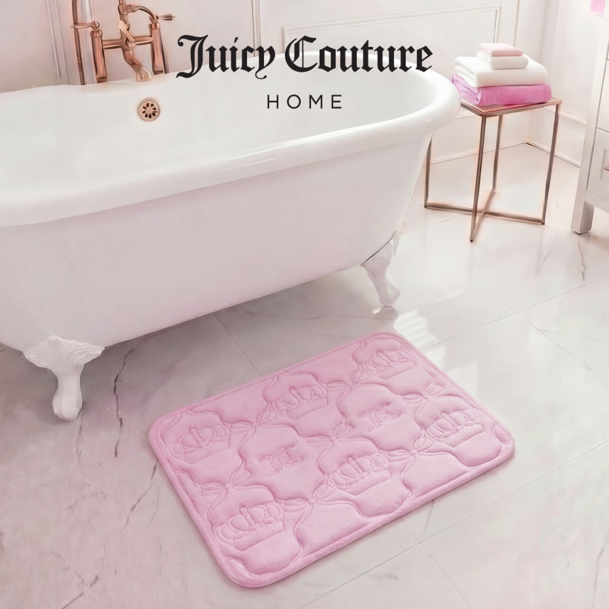 A pink Quilted Memory Foam Bath Mat, 17" x 24", with crown patterns rests on a glossy white bathroom floor by a classic tub. Folded towels are stacked on a gold stand, creating the ultimate glam bathroom scene.