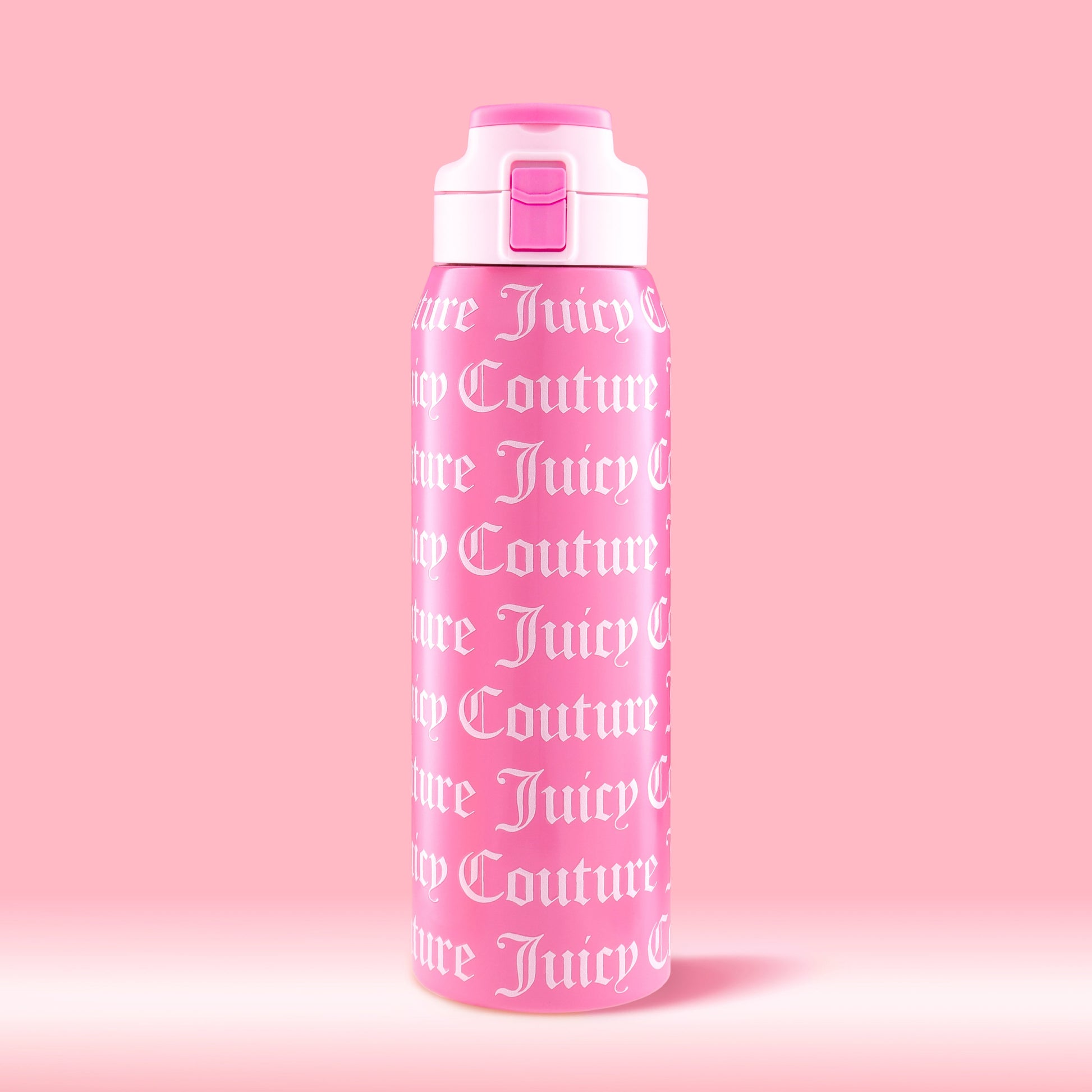 The Glam Getaway Hydration Stainless Steel Tumbler is a 32oz pink Juicy Couture tumbler with a white lid, flip-top spout, and “Juicy Couture” in bold white gothic letters—perfect for stylish, everyday hydration.