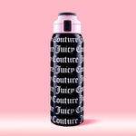 The Glam Getaway Hydration Stainless Steel Tumbler in black features bold white Juicy Couture logos across its surface, a pink and black lid, and is displayed against a solid pink background.