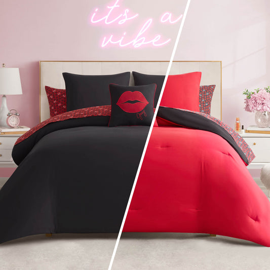 A split image shows the Cheetah Rebel Lips Solid Reversible Bed in a Bag Bedding Set: one side features a black comforter with red accents, the other is red with black accents. The room has light pink walls and a neon sign above the bed.