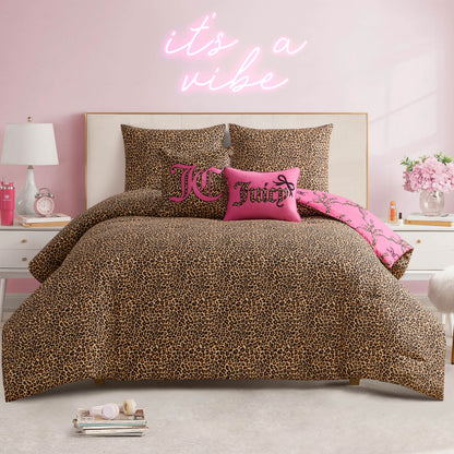 A bedroom featuring the Cheetah Bow Trellis Reversible Comforter Set, pink accent pillows, and an "it's a vibe" neon sign on a pink wall. White nightstands display lamps, flowers, and decor for a bold, fashion-inspired style.