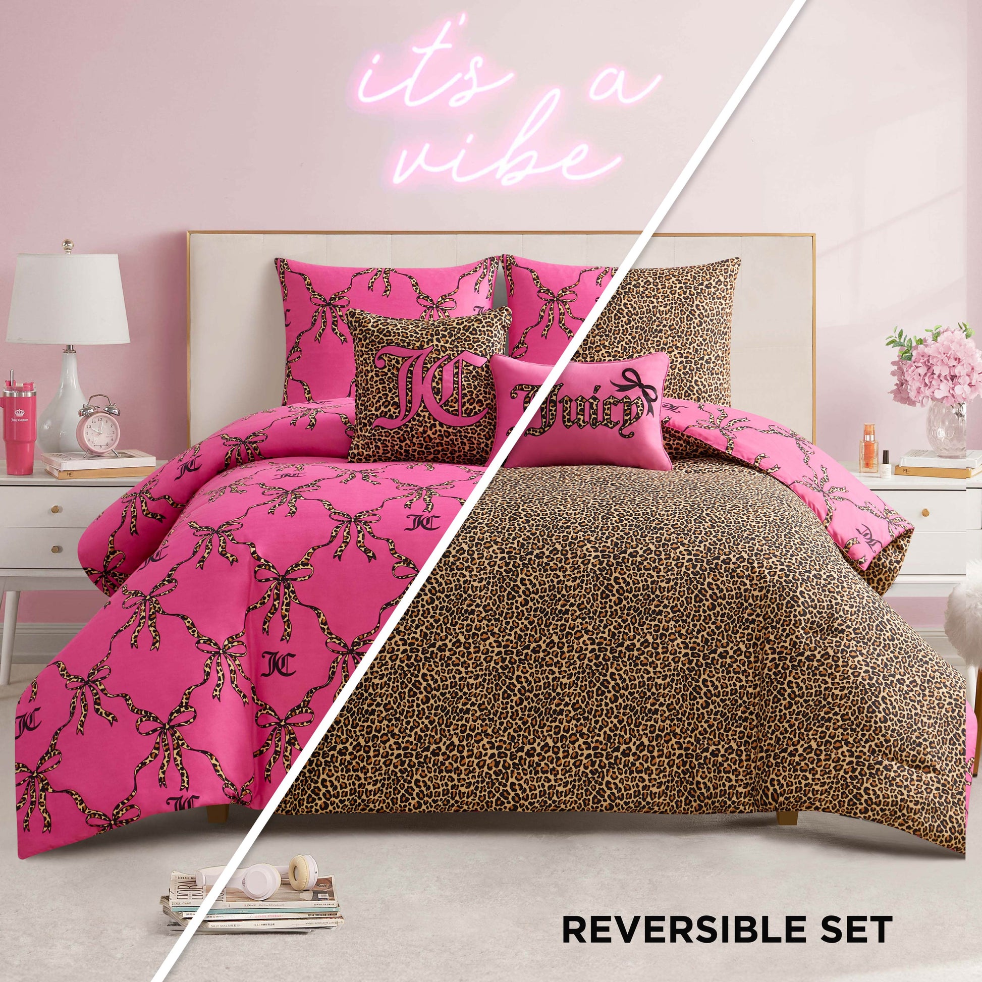 A bedroom featuring the Cheetah Bow Trellis Reversible Comforter Set—pink with black and gold chains on one side, leopard print on the other. Includes a white bed, pink walls, neon "it's a vibe" sign, and chic fashion-inspired decor.