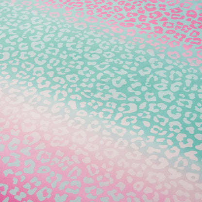 Featuring a gradient leopard print with turquoise at the top blending into pink at the bottom, accented by white and light spots throughout, the Kids Rainbow Ombre Leopard Reversible Comforter Set is a vibrant addition to any kid's bedroom.