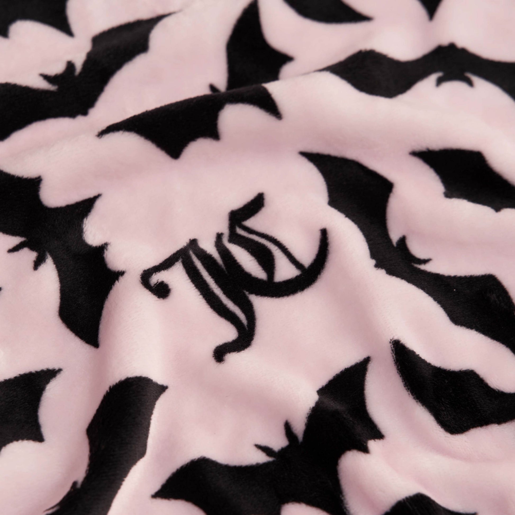 The Halloween Plush Throw Blanket 50" x 60" is a soft pink throw with black bats and a black WC monogram—ideal for Juicy Couture Halloween blanket fans or as stylish, cozy Halloween décor.