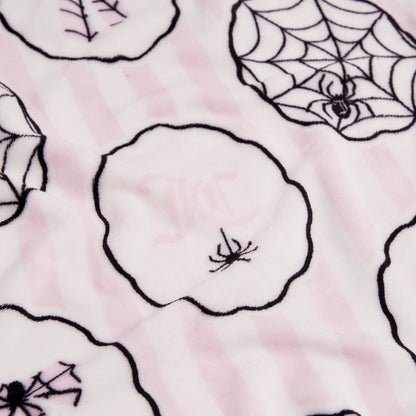The Halloween Plush Throw Blanket 50" x 60" features soft fabric with light pink and white stripes, black-outlined circles, and line art spiders and webs—perfect for cozy, festive décor.