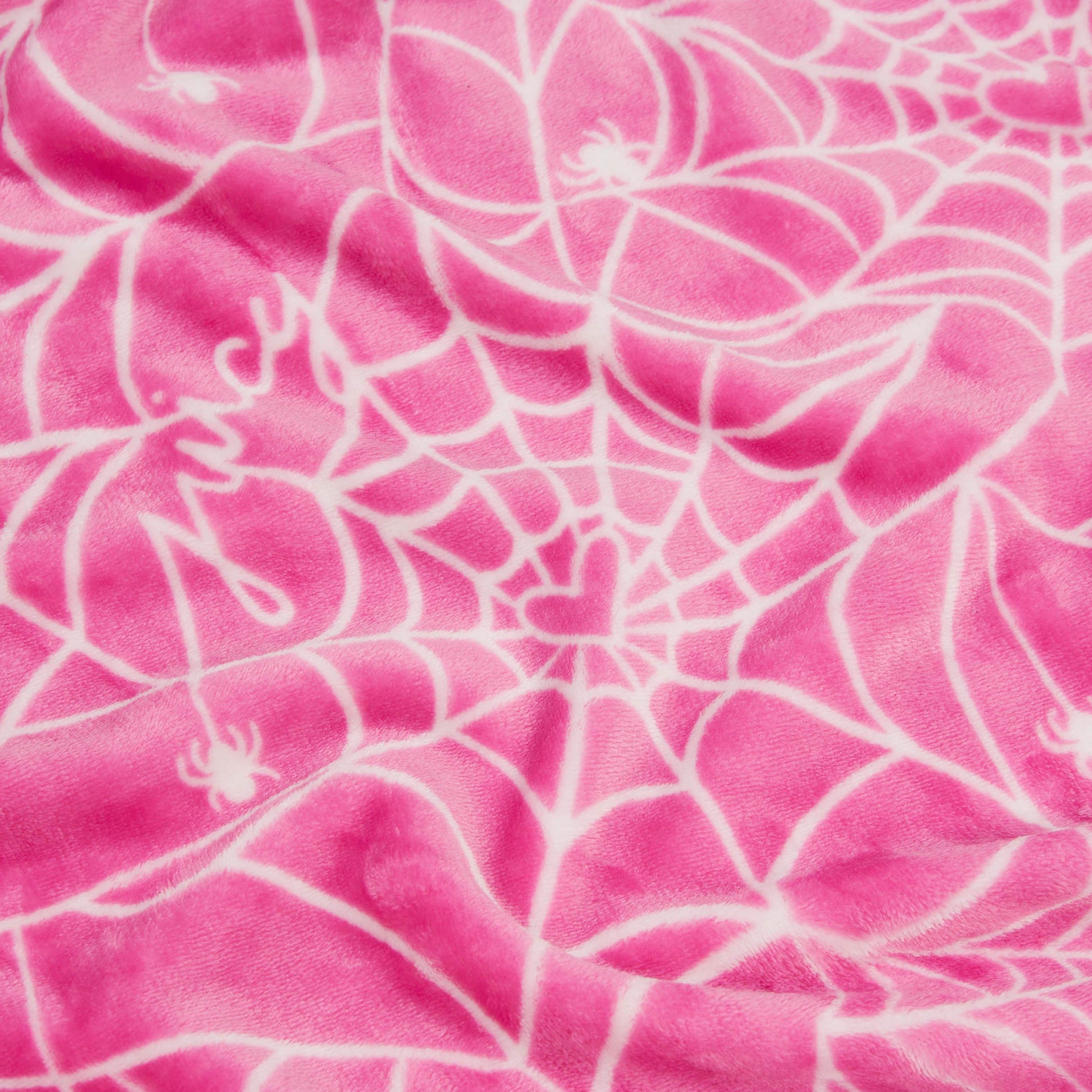 The Halloween Plush Throw Blanket 50" x 60" features pink fabric with a white spiderweb, small spiders, a heart at the web’s center, and “Juicy” in script—perfect as a cozy Juicy Couture Halloween or plush throw blanket.