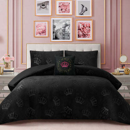 A bedroom with a pink accent wall, floral decor, and framed art. The bed features a tufted headboard adorned with the Embossed Plush Crown Comforter Set, which showcases elegant crown patterns and includes a matching decorative pillow.