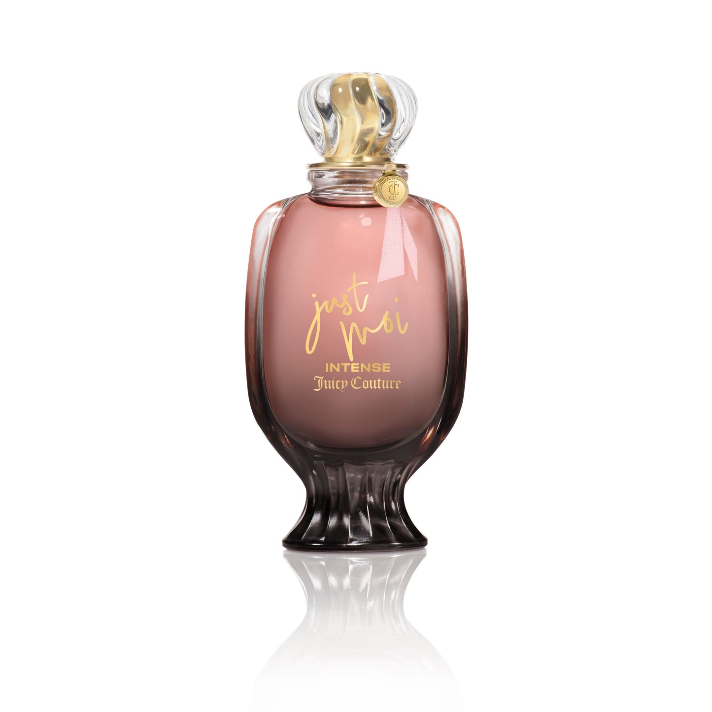 A pink and gold Just Moi Intense Eau de Parfum Spray, 3.4 oz by Juicy Couture stands upright on a white background, featuring a decorative cap and curved glass—an Amber Vanilla scent designed for women.