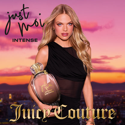 A blonde woman in a black dress holds an oversized bottle of Just Moi Intense Eau de Parfum Spray, 3.4 oz, against a sunset cityscape with Juicy Couture and Just Moi Intense text overlaid.