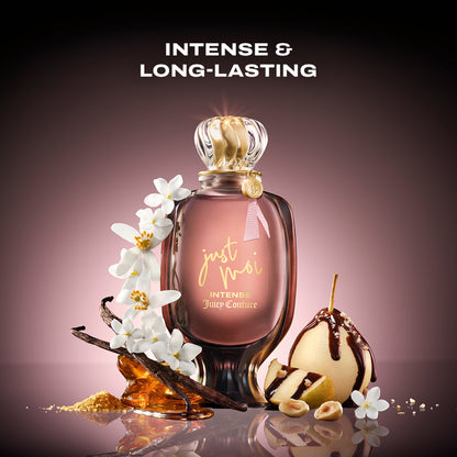 A Just Moi Intense Eau de Parfum Spray Pen, 0.33 oz, is surrounded by white flowers, vanilla beans, caramel, sliced pear with chocolate drizzle, and hazelnuts. The text above reads "Intense & Long-Lasting." This women’s fragrance has an Amber Vanilla profile.