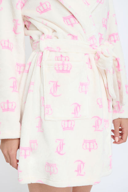 Wearing the Hooded Luxe Plush Robe in cream with pink crown and J designs, a person rests their hand by the pocket. The ultra-cozy robe features a hood, waist tie belt, and convenient pocket.